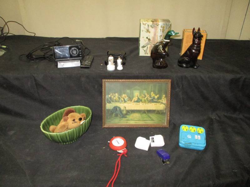 lot 111 image: Avon Filled with Wild Country Cologne, Lords Supper Picture, Phone Charger Ends and Accecories, Ty Beanie and Haeger Planter and Stop Watch
