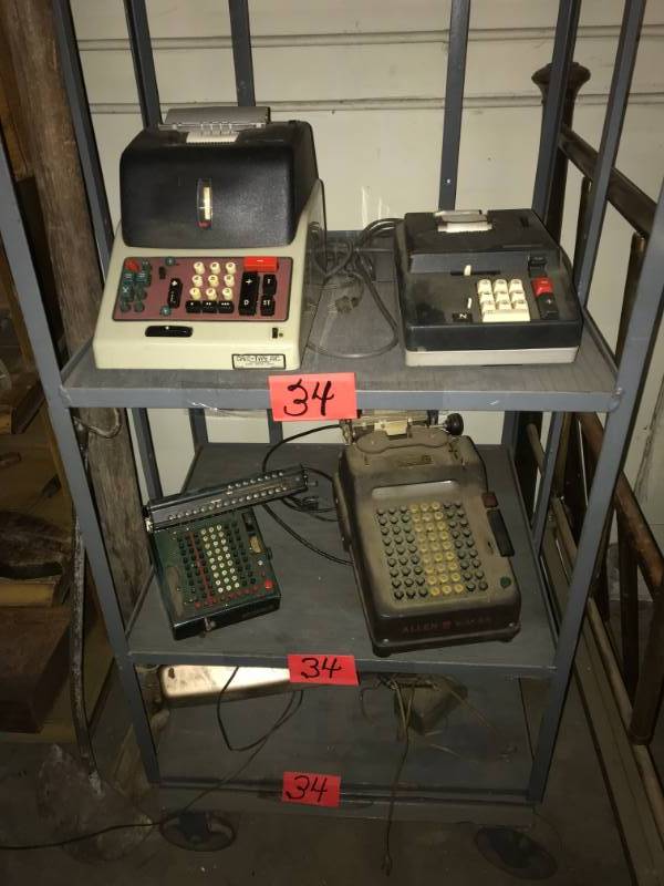 lot 34 image: Three Shelves of vintage adding machines and lamps