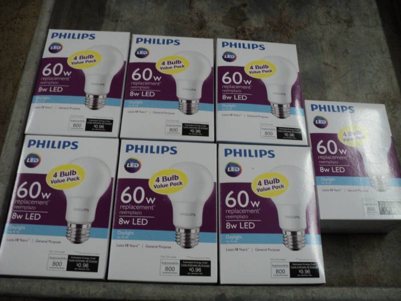 lot 62 image: 7 Philips 4 Packs of LED 60 W Light...
