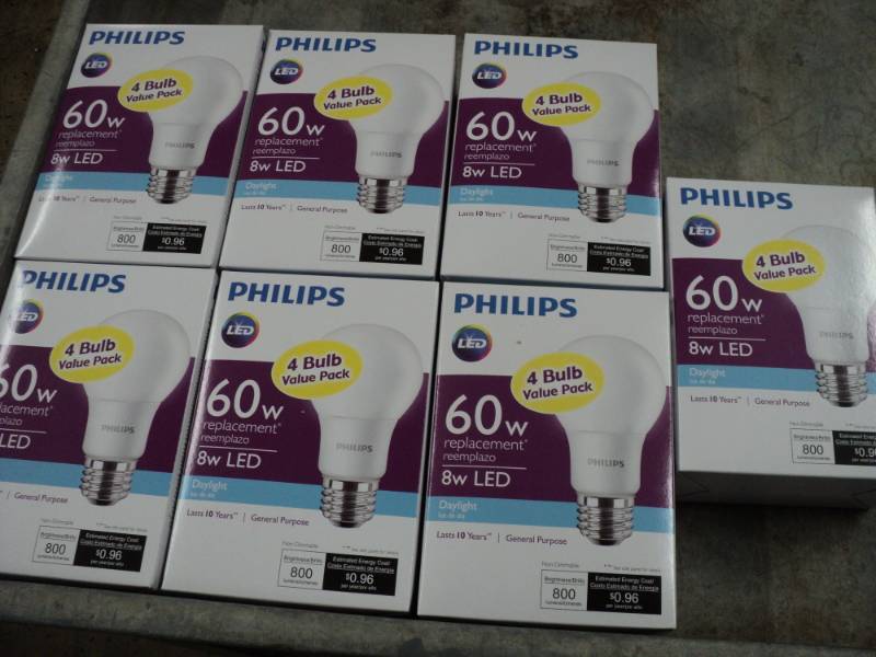 lot 63 image: 7 Philips 4 Packs of LED 60 W Light...