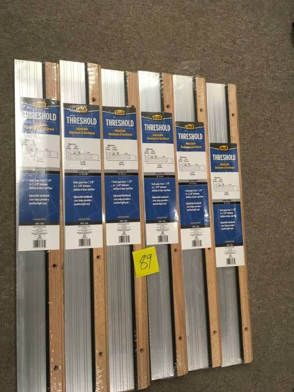 lot 89 image: M-D Building Products 4-916 in. x 36 in. Satin Aluminum and Oak Adjustable Threshold QTY 6 not used