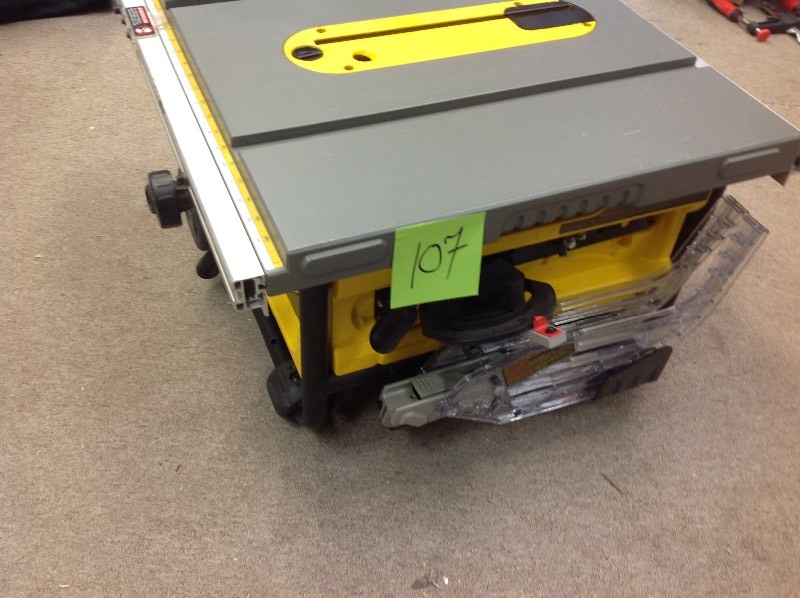lot 107 image: DEWALT 15 Amp 10 in. Compact Job Site Table Saw with Site-Pro Modular Guarding System in working conditions Tool Only missing saw guide and rip fence