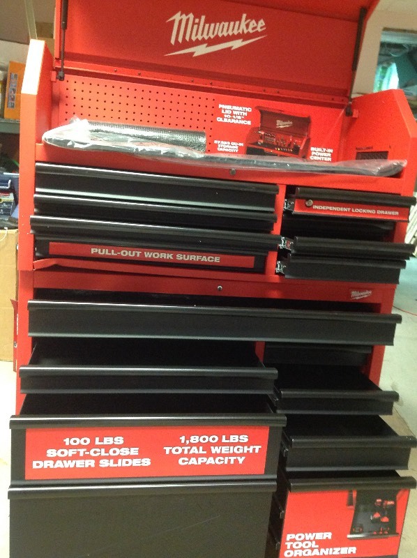 lot 101 image: Milwaukee 46 in. 16-Drawer Steel Tool Chest and Rolling Cabinet Set, Textured Red and Black Matte whit damage one door need help to open