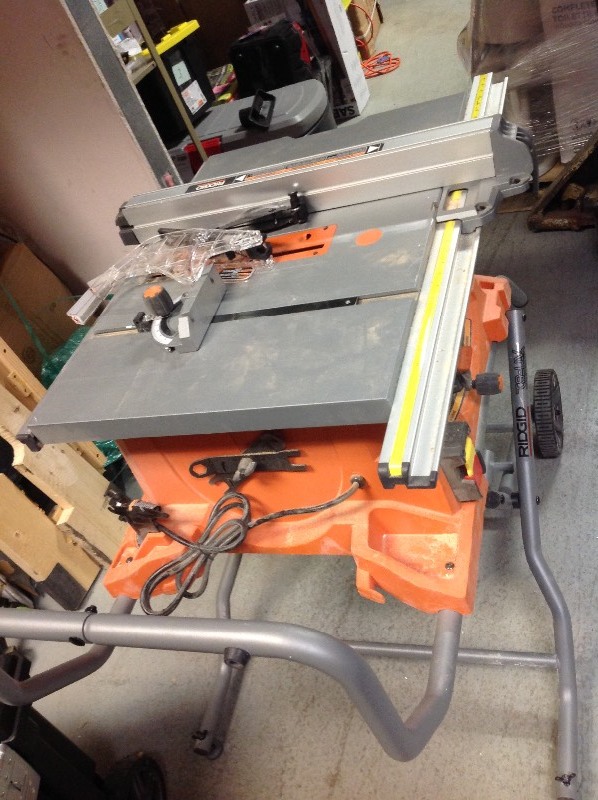 lot 114 image: RIDGID 15 Amp Corded 10 in. Heavy-Duty Portable Table Saw with Stand used in working conditions