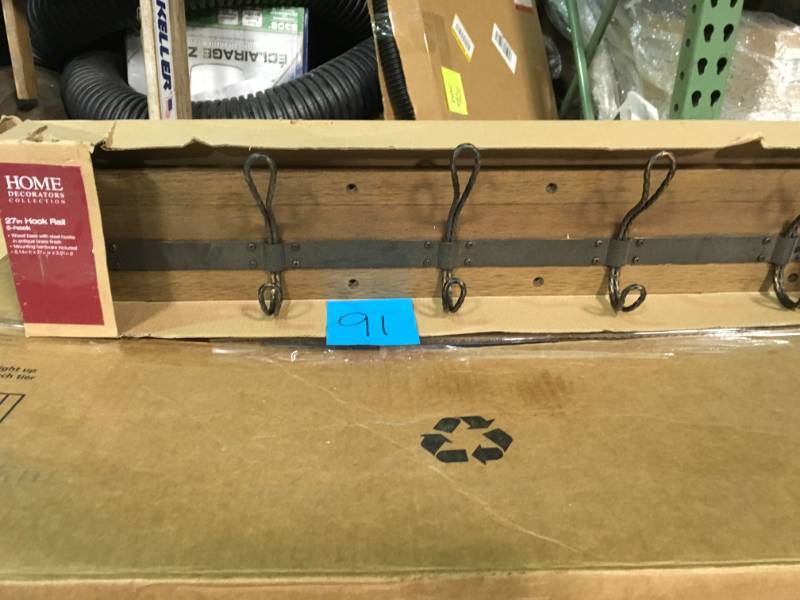 lot 91 image: Home Decorators Collection 27 in. Decorative 5-Hook Key Rail in Antique Brass in very good condition