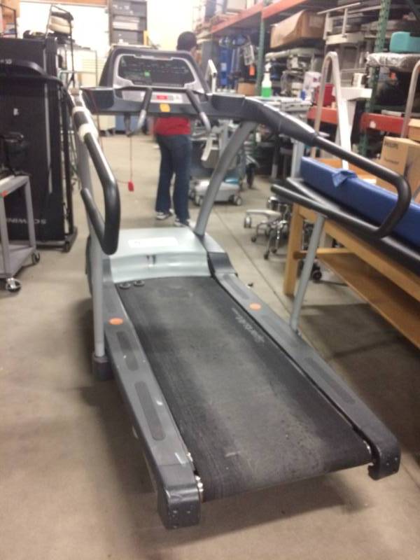 lot 17 image: MSRP $8,000 Professional Medical&nbspSportsArt Industrial Fitness T652M Treadmill - Excellent Working Condition Tread has wear and left rail is taped.