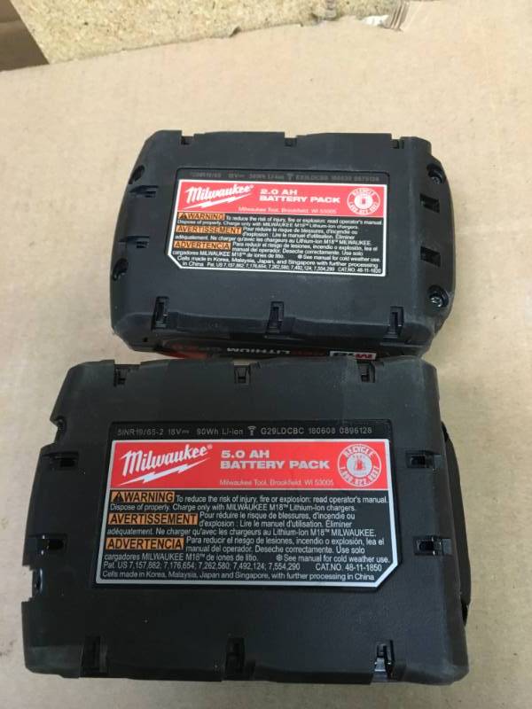 lot 59 image: ONE Milwaukee M18 18-Volt Lithium-Ion XC Extended Capacity Battery Pack 5.0Ah PLUS ONE M18 18-Volt Lithium-Ion Compact Battery Pack 2.0Ah QTY 2 used in good condition