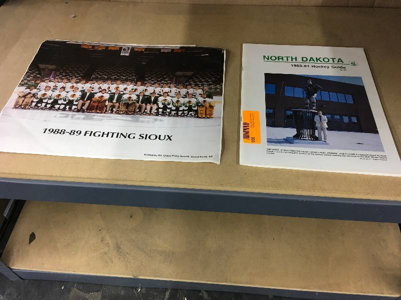 lot 331 image: 1988- 1989 UND Fighting Sioux Hockey Poster & 1983- 1984 UND Hockey Guide