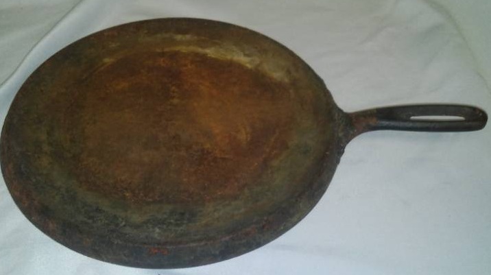 lot 134 image: Cast griddle, 10.5 in  around. NG 9 on reverse.
