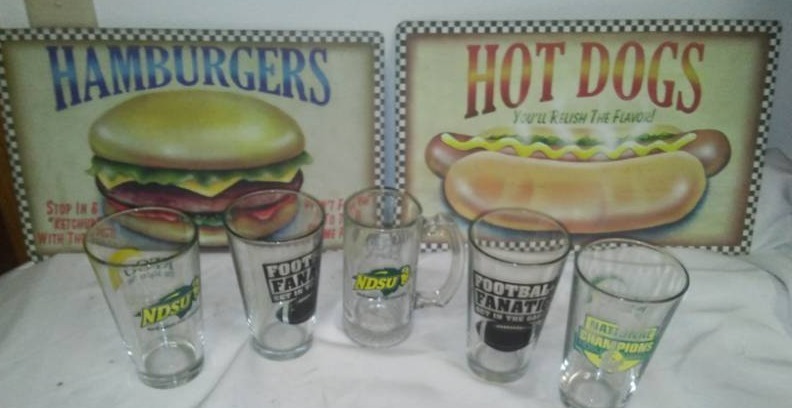 lot 139 image: Metal signs and bison glasses.