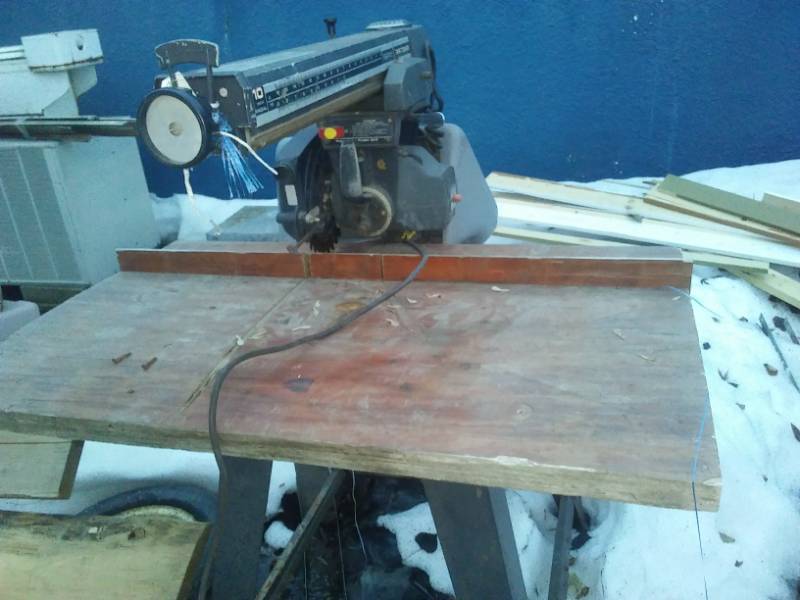 lot 144 image: Sears Craftsman 10 radial arm saw on tip back 2 roller stand. Used.