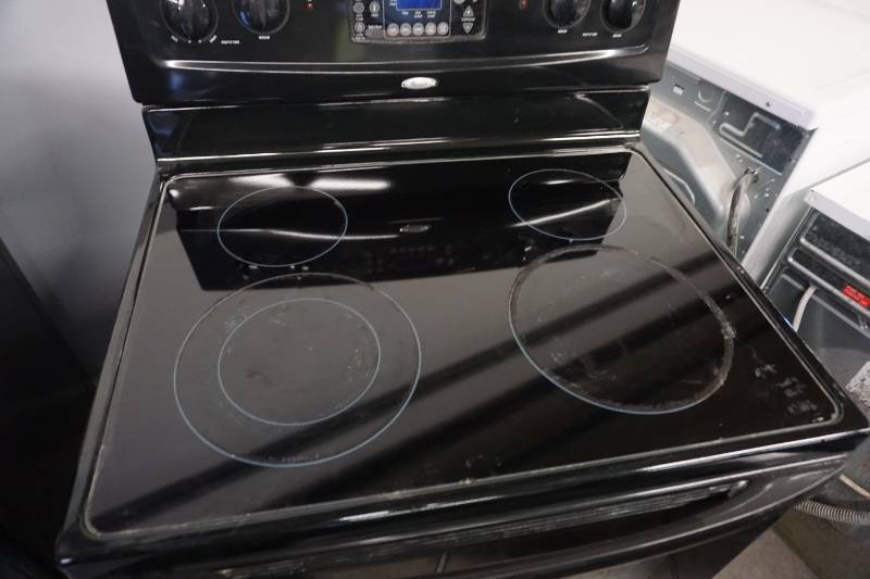 lot 21 image: Whirlpool Electric RangeStove With Under Counter Mount Fan
