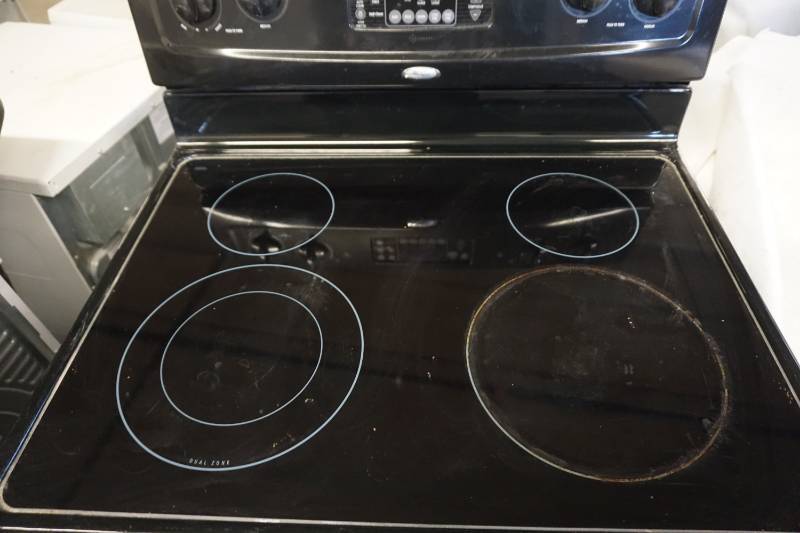 lot 24 image: Whirlpool Electric RangeStove With Under Counter Mount Fan