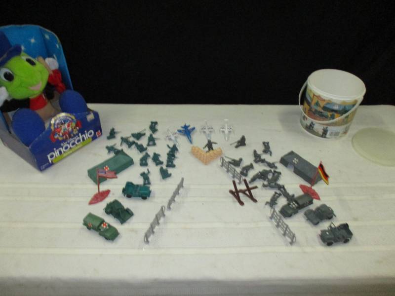 Pinnochio and Army baracks and men sey