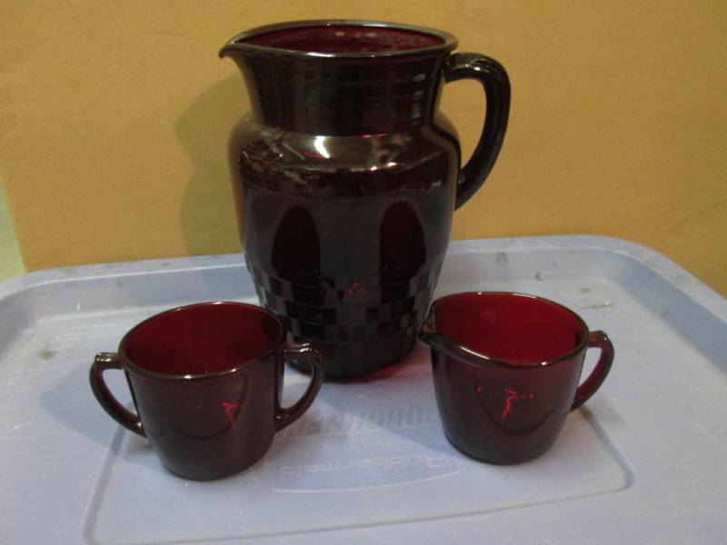 lot 37 image: Red Glass 3-Piece Pitcher, Creamer ...