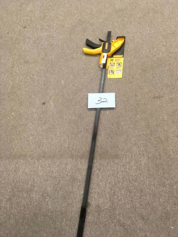 lot 32 image: DEWALT 36 in. 300 lb. Trigger Clamp w3.75 in. Throat Depth in good condition