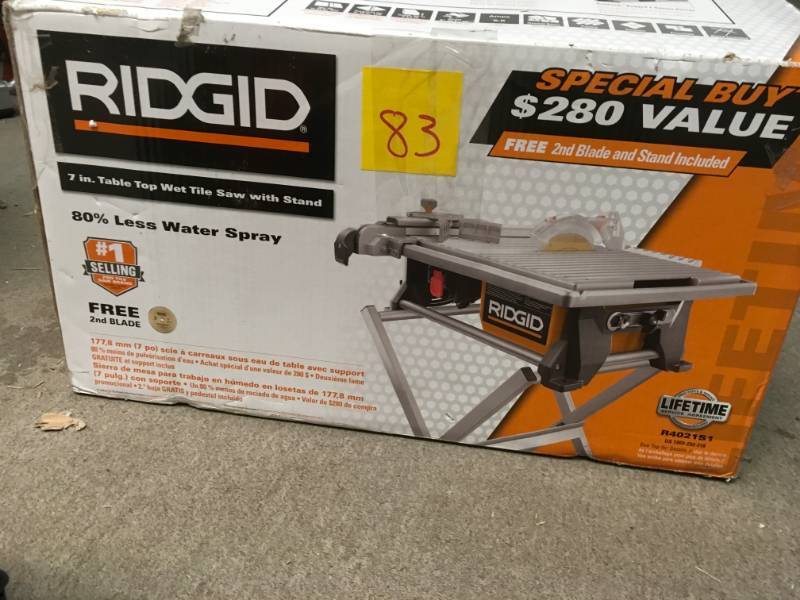 lot 83 image: RIDGID 6.5 Amp 7 in. Table Top Wet Tile Saw with Bonus Stand and Blade in working conditions