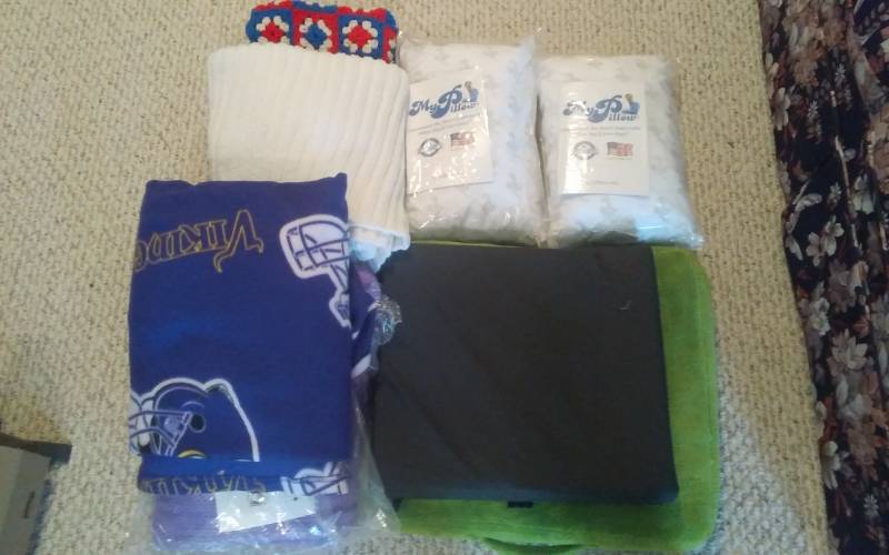 lot 14 image: My Pillow Travel Pillows, Afgans, Blankets, Pads, Vikings Snuggle Blanket