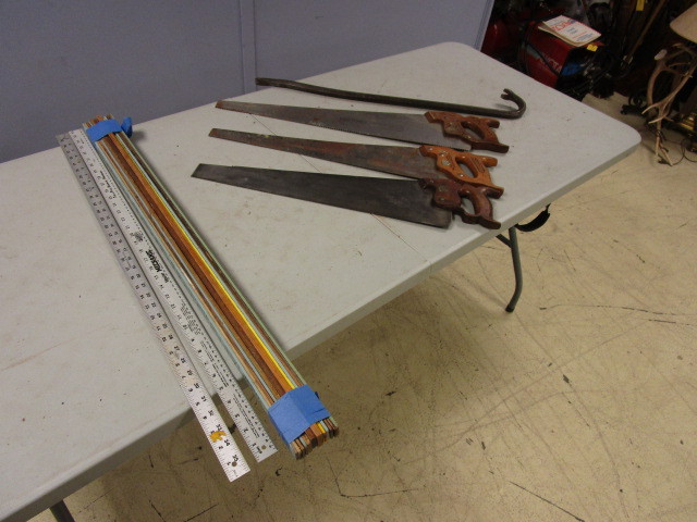 lot 421 image: VINTAGE HAND SAWS, A CROWBAR AND A QUANTITY OF YARD STICKS