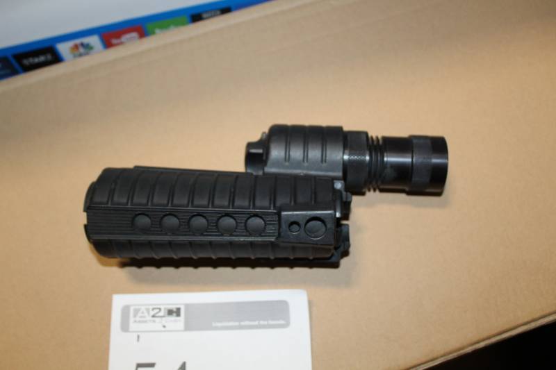 lot 54 image: Sure Fire AR15 Fore-End Gun-Mount Flashlight