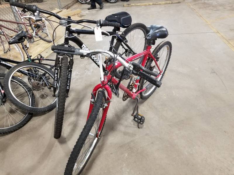 lot 459 image: Lot of (2) Bikes that need repair - Including Mongoose, Black Mongoose Excurision bike. Broken pedal., 23  Inch Rim Diameter & Magna, Red Magna Glacier point bike. 20 speed. , 21  Inch Rim Diameter