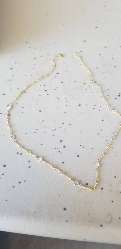 lot 290 image: Gold Tone Necklace With Small Diamond Like Stones in the Links