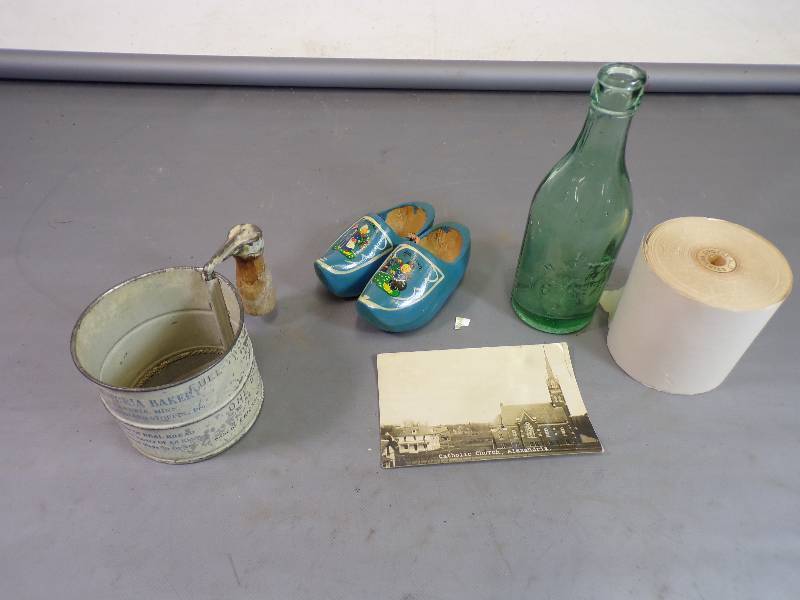 lot 88 image: Alexandria MN Post card, Kraemer Bottle Bakery siffe3r, Paper roll and Blue wood child shoes
