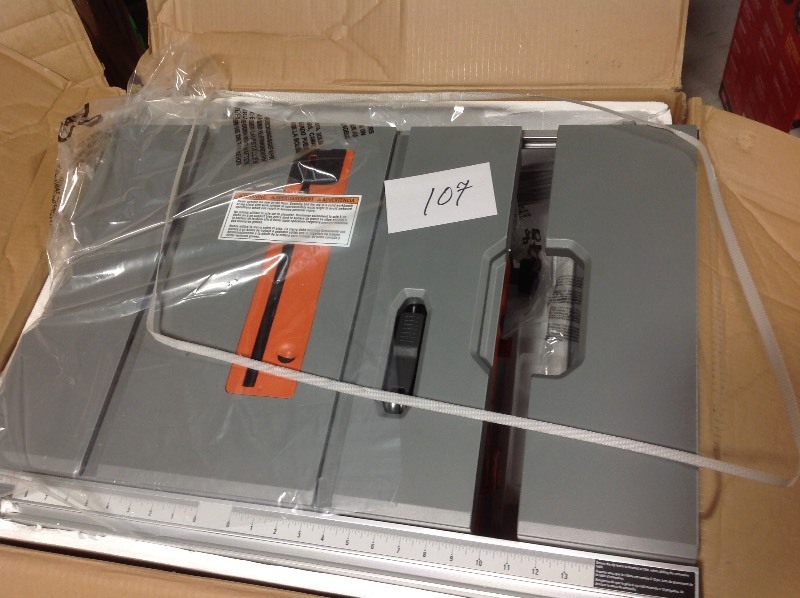 lot 107 image: RIDGID 15 Amp Corded 10 in. Compact Table Saw not used missing pcs for the stand and rip fence in working conditions