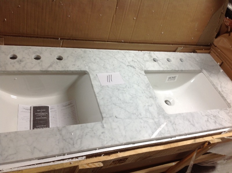 lot 111 image: Home Decorators Collection 61 in. W x 22 in. D Marble Double Trough Sink Vanity Top in Carrara crack in one side please review the photos