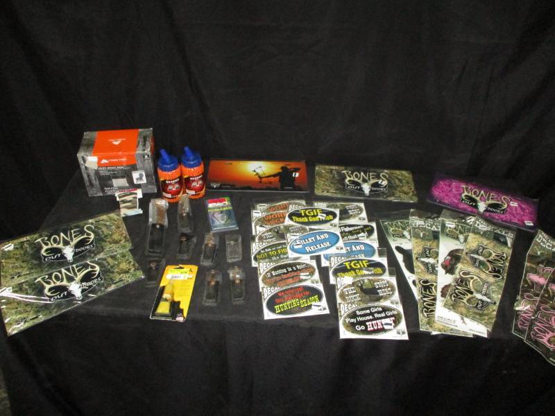 lot 147 image: Several Hunting Decals both male and female, Vanity plates, air soft pellets, and folding knifes all new its original packaging