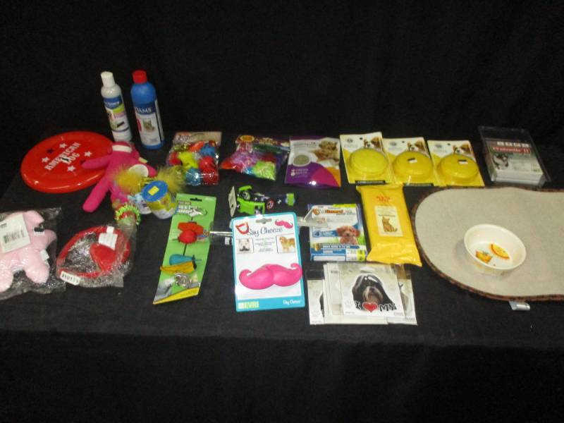 lot 159 image: Pet Shampoo and cat toys, can covers, cat dish and mat pad for the dishes, smily face toy for dog to chew on and stickers for your pets