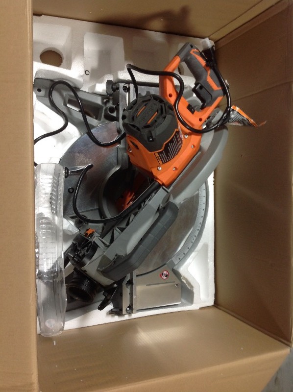 lot 104 image: RIDGID 15 Amp Corded 12 in. Dual Bevel Miter Saw with Adjustable Laser Guide, Carbide Tipped Blade, and Dust Bag in working conditions whit small damage guard