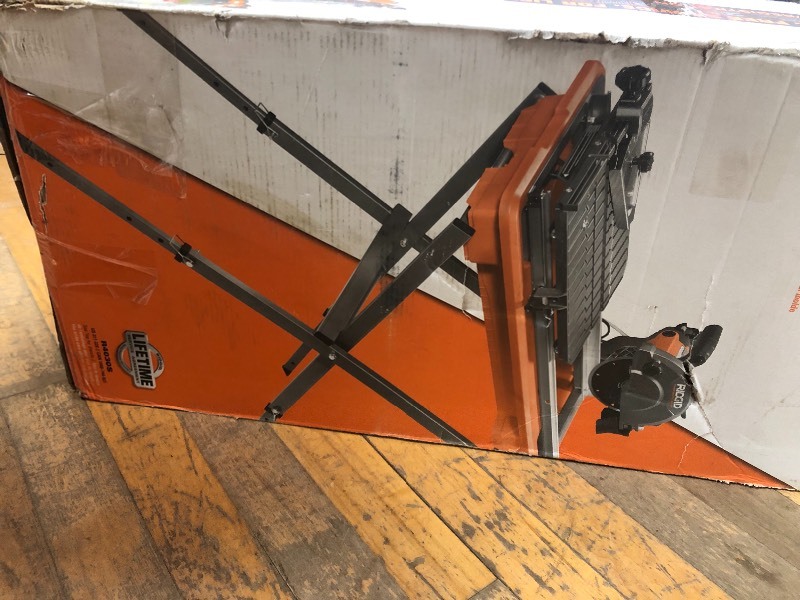 lot 119 image: RIDGID 7 in. Tile Saw with Stand in good working conditions