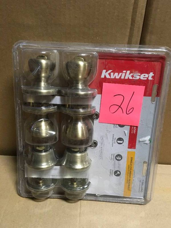 lot 26 image: Kwikset Tylo Antique Brass Exterior Entry Door Knob and Single Cylinder Deadbolt Project Pack in good condition