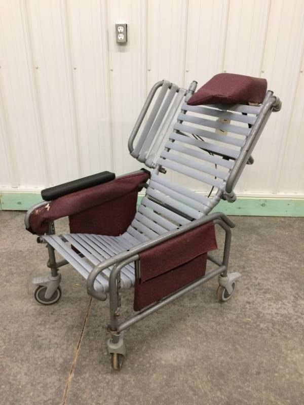 lot 33 image: OUTDOOR TILTING & RECLINING WHEELCHAIR - WORKS BUT NEEDS CUSHIONS TO BE REPLACED