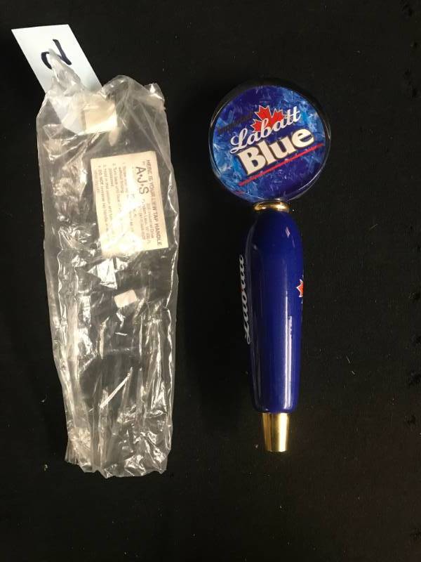 lot 132 image: Labatts Blue hockey puck tap handle - NIP