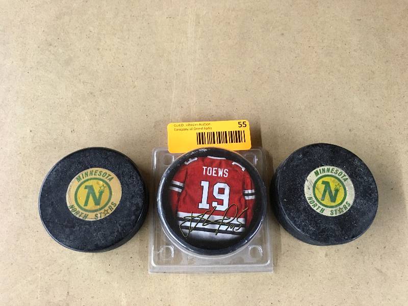 lot 55 image: Jonathan Toews Puck & Two Minnesota North Stars Pucks