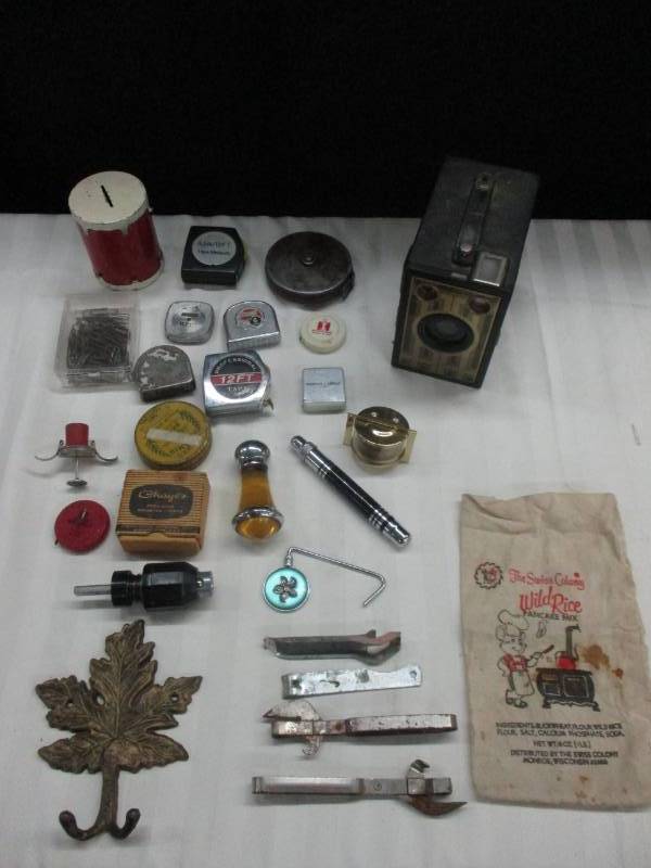 lot 6 image: Advertising Tape Measures, Old Camera, Bottle Openers, Old candle, old flashlight, lots of collectibles, Drum Bank