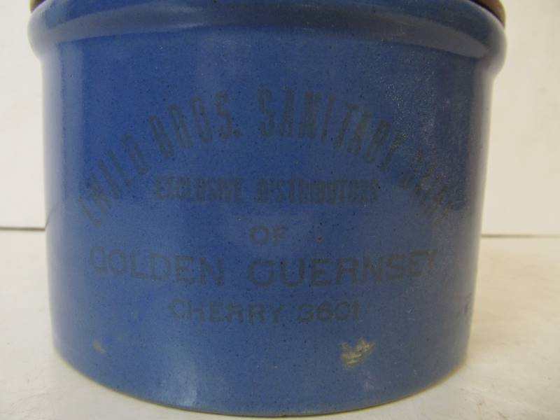lot 54 image: Vintage EWALD BROS Golden Guernsey Advertising Stoneware Crock