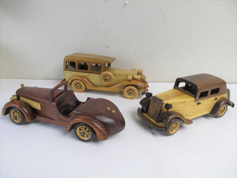 lot 86 image: Group of 12 Solid Wood Antique Style Cars