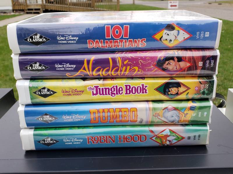 lot 114 image: (5) Black Diamond Disney VHS Movies, (2) VHS Players Sharp and Realistic, (1) Tape Deck Technics