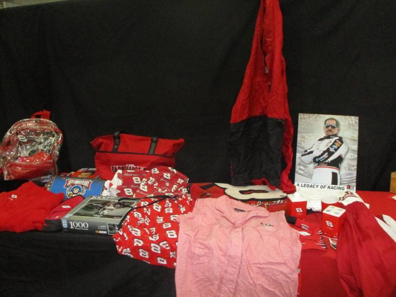 lot 128 image: Whole Lot of Dale Earnhardt SR. Shower Curtains, Grilling  Hat and Apron Set, Coats, Pants, Poajama pants, Bathrioom Set, Rug, Duffle Bag, Magnets, Licence Plates, Books and so much more