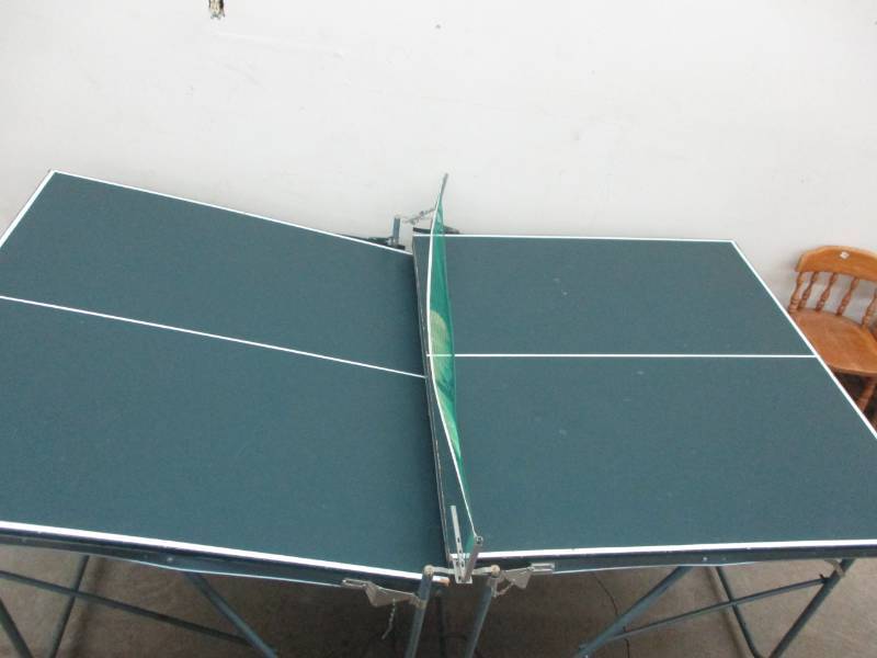 lot 37 image: Ping Pong Table, One side needs some adjusting and then it will match together. Table is nice on top and there is a net.