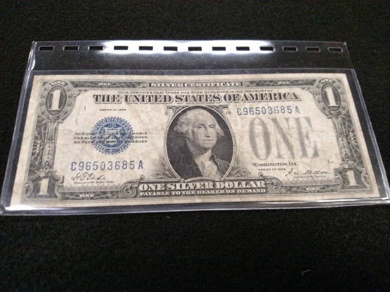 lot 115 image: 1928 Funny Back One Dollar Silver C...