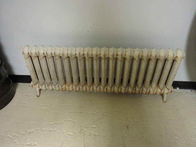 lot 210 image: CAST IRON FLOOR MOUNTED RADIATOR HEATER