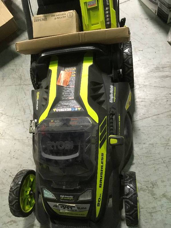 lot 13 image: Ryobi. 20 RY40190 40-Volt Brushless Lithium-Ion Cordless Battery Self Propelled Lawn Mower with 5.0 Ah Battery and Charger Included in good condition