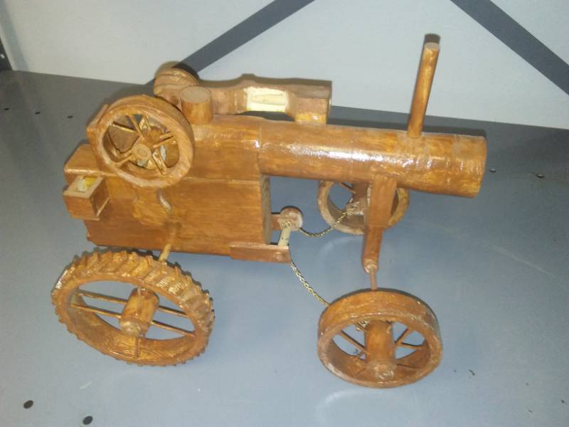 lot 16 image: Wood tractor, 13in, with steering chains and working hydraulic wheel.