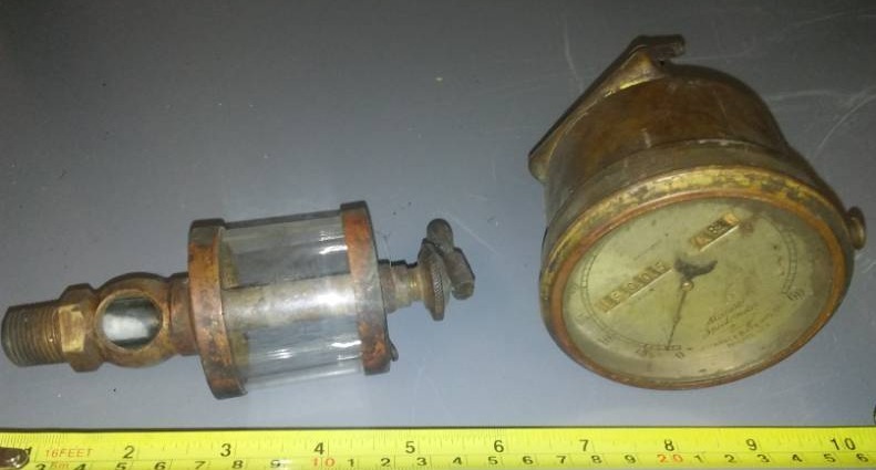 lot 74 image: Antique auto speedometer and glass fuel globe Thomas Stewart and Clark Manufacturing.