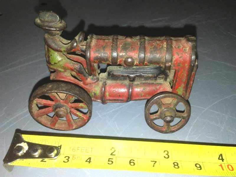 lot 103 image: Vintage cast steel wheel tractor.