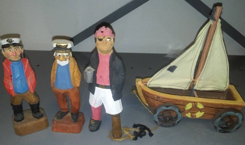 lot 199 image: Wood Carved crew members  captain, first mate and Pegleg Pete and car boat.